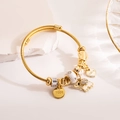 Adjustable gold charm bracelet with heart and elephant pendants on a stone background - Gold Elephant