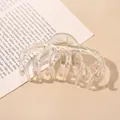 Macro shot of large iridescent acrylic hair claw clip with colorful laser finish effect - Transparent AB Pumpkin Hair Claw