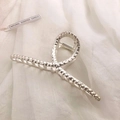 Detailed view of silver alloy hair claw clip with hammer texture on soft fabric - Matte Silver-Hammered Cross