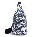 White nylon crossbody chest bag featuring a navy blue leaf floral print and adjustable strap - White with Blue Flowers