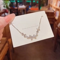 Elegant silver bow necklace featuring cubic zirconia flower accents on a gift card - S248 Silver