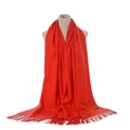 Detail of red cashmere-feel scarf with elegant fringes displayed on a mannequin - Orange Red