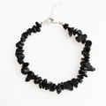 Close-up of irregular black obsidian stone bracelet with silver lobster clasp and chain - Black Agate