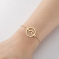 Minimalist gold cross bracelet featuring a round hollow wave pendant on a delicate chain - 345-Hollow Wave Disc / Gold