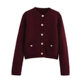 Detailed view of burgundy knit cardigan featuring gold buttons and ribbed cuffs - Burgundy