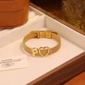 Gros plan du bracelet en maille dorée avec charm en cœur et détail de la lettre P - Lettre P