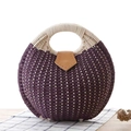 Fashionable round purple straw handbag with elegant woven handles and leather buckle detail - Purple