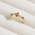 Macro shot of an oval red gemstone ring with small diamonds on a white fabric background - Red Oval Stone Simple Style (款式8)