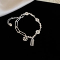 Detail of silver bracelet with mini abacus and copper coin charms on black velvet - Abacus and Coin Pendant Style / Silver