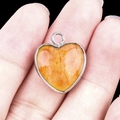 Orange marbled heart pendant with silver metal bezel and top hanging loop - Yellow Tinted Quartz Silver Edging