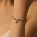 Elegant 18K gold-plated beaded bracelet featuring a polished 3D heart charm on a wrist - Heart Ball Chain (I212) / I212 Gold Bracelet