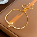 Detailed view of gold-plated clover bracelet with adjustable slider clasp and cubic zirconia - Gold