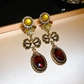 Macro shot of vintage gold-plated floral earrings featuring red stones and bow detail - Gold Yellow Bowknot Long Style (26#)