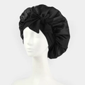 Black satin sleep cap with bow detail on mannequin head showing elastic band and texture - One Size / Black