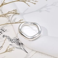 Close-up of polished silver wavy stainless steel ring on minimalist display stand - US 7 / Thick Wave Ring J309 / Steel