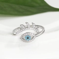 Macro detail of silver evil eye open ring with blue stones and shimmering eyelashes - Evil Eye Fan Eyelash (Q-J079) / White Gold