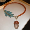 Detailed close-up of vintage acorn necklace with orange beads and blue rhinestone charms - 84# Necklace Vintage Rhinestone Crystal Leaf Pinecone OT Buckle