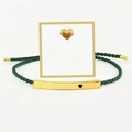 Detailed shot of green woven bracelet with gold 'Just breathe' bar and gift card - Just Breathe Gold Bar Green Rope With Card
