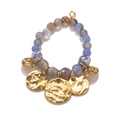 Handmade boho agate bead bracelet with golden hammered metal charms on white background - Blue