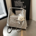 Versatile silver metallic backpack with bow detail and plush charm for women - Silver
