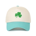 Close-up of green shamrock embroidery on a beige and green two-tone baseball cap - Beige Crown + Lake Blue Brim