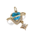 Macro shot of blue heart Saturn pendant with gold plating and sparkling star charm - Blue Heart Planet