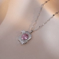 Primer plano de collar de plata con gema ovalada rosa y detalle floral en seda rosa - Color Acero Circón Rosa