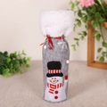 Detail of grey felt Christmas wine bottle cover with snowman embroidery and faux fur trim - Snowman