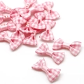 Pink gingham fabric bow with white plastic buttons for DIY craft and sewing decorations - Pink
