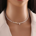 White beaded necklace with gold heart and 'Y' letter pendant worn by a model - Letter Y