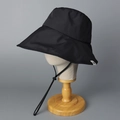 Detail of black wide-brim sun hat featuring an adjustable windproof drawstring and side label - Black
