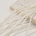 Detailed view of 3mm natural white freshwater shell round beads on a stone for DIY jewelry - 6# White Shell Round Beads / Approx. 126pcs/3-3.5mm