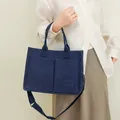 Navy blue felt tote bag with dual front pockets and adjustable crossbody strap - Blue