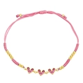 Detail of pink hand-woven cord bracelet with three gold heart pendants and zircons - Rose Red