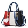 Red, white, and black tricolor patchwork handbag with gold bow and pearl tassel - Blue