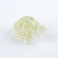 Translucent green resin turtle figurine with gold foil flakes on a white background - 11 Lemon Citrine + Gold Foil