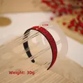 Red rhinestone headband with 2.7cm width and 30g weight on a display stand - Red Rhinestone