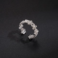 Detail shot of silver hollow floral pattern on adjustable open ring with metallic texture - Hollow Flower Style (Style 1)