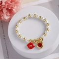 Detail of beaded bracelet with 18k gold beads, white pearls, red lips and bunny ear charms - Red Lips and Heart Rabbit Ear (D)