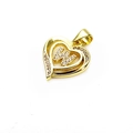 Close-up of golden heart pendant with sparkling zircon diamonds and the letter K detail - Letter W