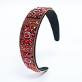 Détail d'un serre-tête en velours rouge avec perles dorées et broderie de fleurs - Rouge