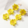 Vibrant yellow flower earrings with multilayered petals and gold accents on white background - Yellow
