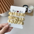 Three-piece satin scrunchies set in creamy yellow on a decorative display card - 3 Piece Set / Beige