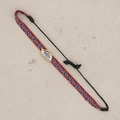 Detail of hand-woven geometric bracelet with blue evil eye charm and adjustable cord - Red Blue White Geometric-Evil Eye