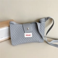 Detail of light blue knit crossbody bag showing diamond texture and metal magnetic snap - Gray