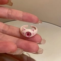 Close-up of pink cat ear ring with pupil detail worn on finger over mirror - Light Pink Cat Ear Eye Style (7#)