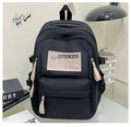 Detail of black nylon backpack featuring brand tag and adjustable side buckles - Basic Style / Black