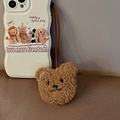 Detail of off-white wavy phone case with brown plush bear charm and motivational text - Plush Bear Charm