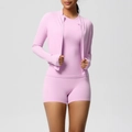 Detail view of pink three-piece yoga set with zip jacket, tank top, and high waist shorts - Sakura Pink