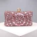 Detailed view of pink rhinestone evening clutch featuring a pearl metal ring clasp - Pink